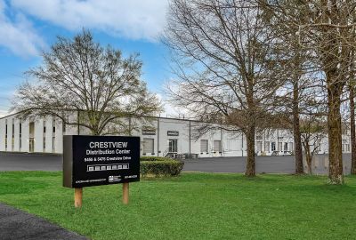 Black monument sign for Crestview Distribution Center in front of an industrial warehouse facility in the Memphis corporate real estate sector.