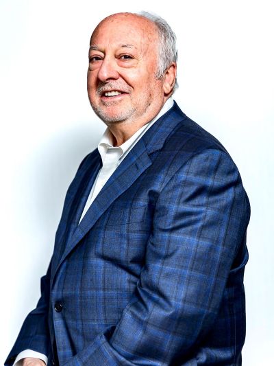 A professional headshot of Gary Makowsky specializing in the Memphis corporate real estate market, wearing a blue plaid blazer against a white background.