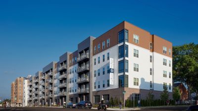 Modern five-story Madison at McLean mid-rise apartment building viewed from street level in Memphis corporate real estate.