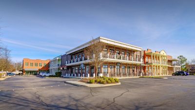Two-story mixed-use commercial and residential loft building featuring columns and balconies in southaven ms
