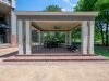 Covered brick patio pavilion with outdoor seating amenities