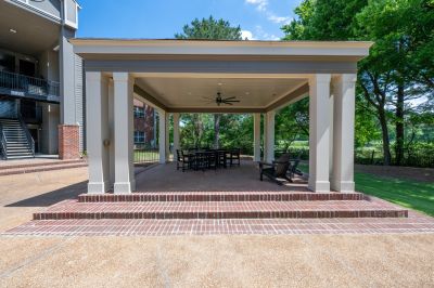 Covered brick patio pavilion with outdoor seating amenities