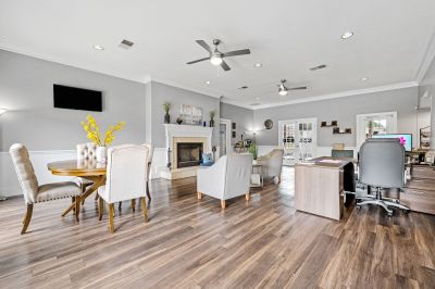 Modern leasing office and resident clubhouse lounge featuring a fireplace and hardwood flooring